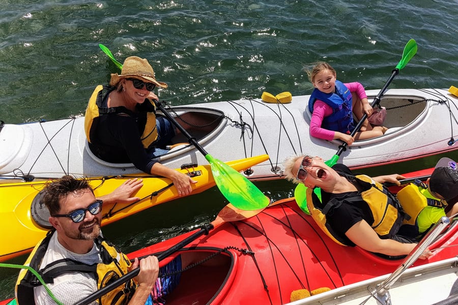 Couple kayaking on calm river near Yamba